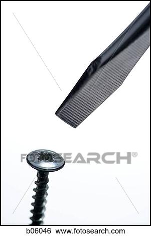 Stock Photograph - A flathead screwdriver and a screw. Fotosearch