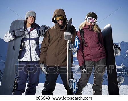 Stock Photo - A group of friends outside in the snow. Fotosearch