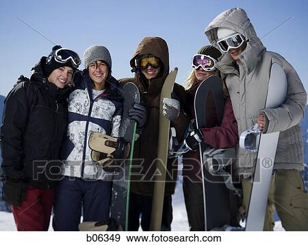 Stock Photo - A group of friends outside in the snow. Fotosearch