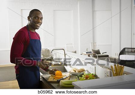 A man preparing food View Large Photo Image Stock Image - A man preparing food. Fotosearch