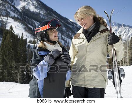 Stock Photography - A mother and her daughter outside in the snow. Fotosearch