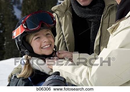A mother helping her daughter outside in the snow View Large Photo Image Stock Photograph - A mother helping her daughter outside in the snow. Fotosearch