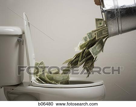 Stock Image - A person pouring a bucket of money down the toilet. Fotosearch