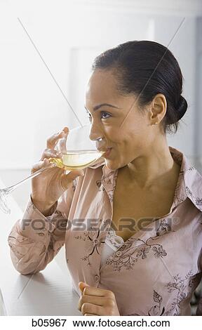 Stock Photo - A woman drinking wine. Fotosearch
