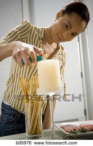A woman preparing for a party View Large Photo Image Stock Photograph - A woman preparing for a party. Fotosearch