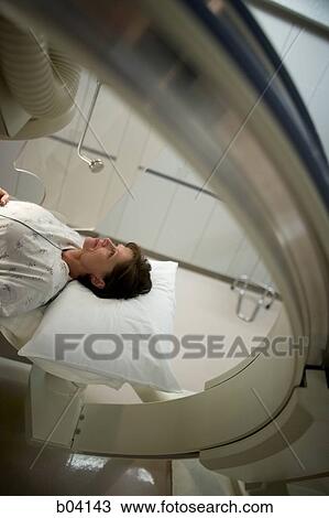 Stock Image - Aerial of woman on diagnostic bed. Fotosearch