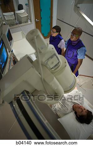 Aerial of woman undergoing x-ray in lab View Large Photo Image Stock Image - Aerial of woman undergoing x-ray in lab. Fotosearch