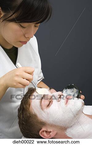 Beautician applying face masque View Large Photo Image Stock Image - Beautician applying face masque. Fotosearch