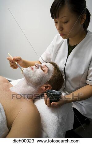 Beautician applying face masque View Large Photo Image Stock Image - Beautician applying face masque. Fotosearch