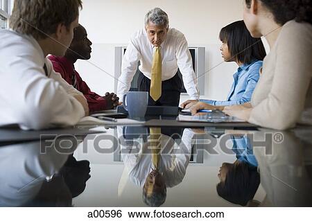 Boss looking stern at business meeting with five people View Large Photo Image Stock Photograph - Boss looking stern at business meeting with five people. Fotosearch
