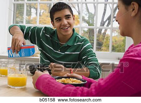 Boy and girl eating breakfast View Large Photo Image Stock Photo - Boy and girl eating breakfast. Fotosearch