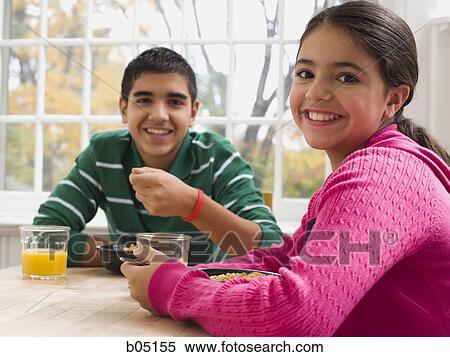 Boy and girl eating breakfast View Large Photo Image Stock Photography - Boy and girl eating breakfast. Fotosearch