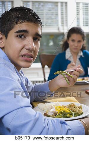 Boy eating green beans View Large Photo Image Stock Photo - Boy eating green beans. Fotosearch