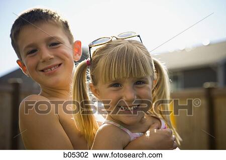 Boy embracing girl smiling View Large Photo Image Stock Image - Boy embracing girl smiling. Fotosearch