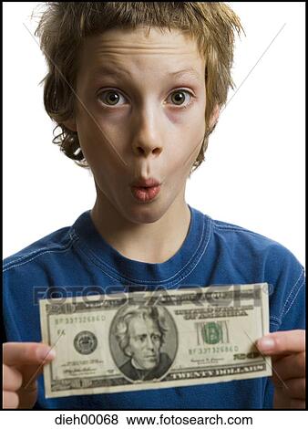 Stock Photo - Boy holding a twenty dollar bill. Fotosearch