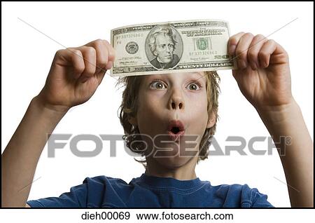 Boy holding a twenty dollar bill View Large Photo Image Stock Photo - Boy holding a twenty dollar bill. Fotosearch