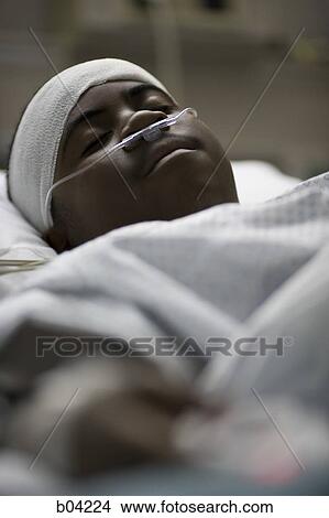 Boy in hospital bed with head bandages View Large Photo Image Picture - Boy in hospital bed with head bandages. Fotosearch