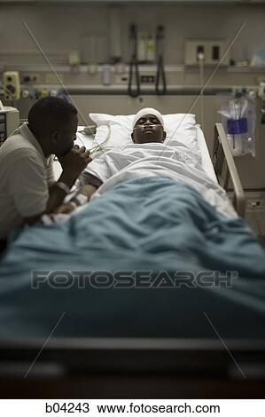 Boy in hospital bed with head bandages with father by his side View Large Photo Image Stock Image - Boy in hospital bed with head bandages with father by his side. Fotosearch