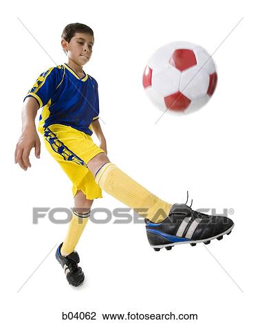 Boy kicking soccer ball View Large Photo Image Stock Image - Boy kicking soccer ball. Fotosearch