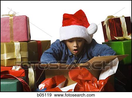 Boy opening Christmas gift View Large Photo Image Stock Photo - Boy opening Christmas gift. Fotosearch