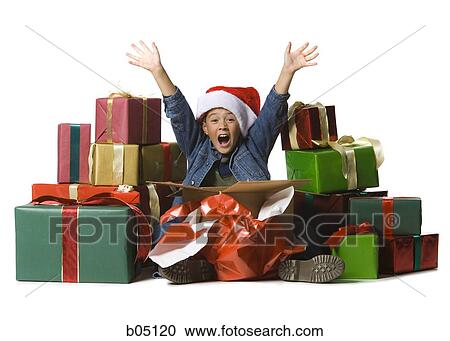 Stock Image - Boy opening Christmas gifts. Fotosearch