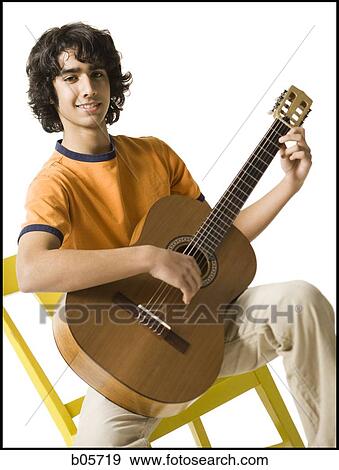 Stock Photo - Boy playing the guitar. Fotosearch