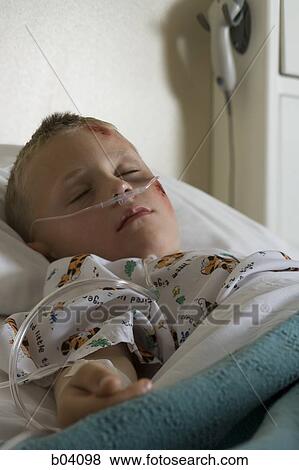 Boy sleeping in hospital bed View Large Photo Image Stock Photo - Boy sleeping in hospital bed. Fotosearch