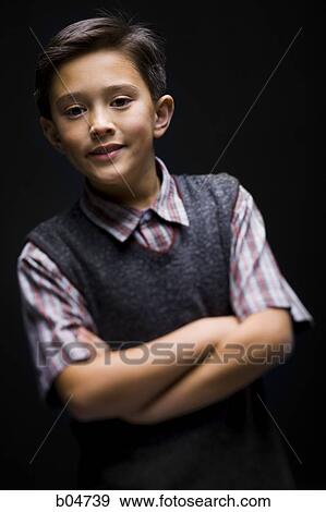 Stock Photo - Boy with arms crossed leaning and smiling. Fotosearch