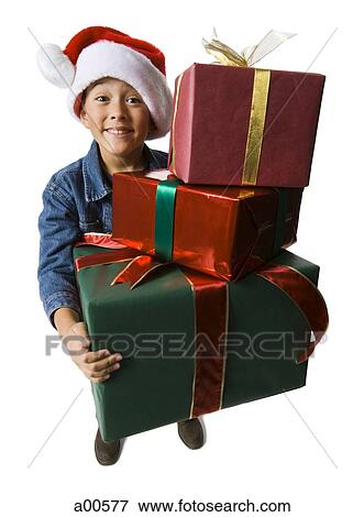 Boy with Christmas gifts and santa hat View Large Photo Image Stock Photo - Boy with Christmas gifts and santa hat. Fotosearch