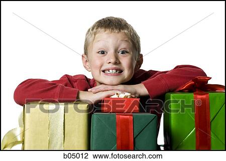 Stock Image - Boy with Christmas gifts. Fotosearch