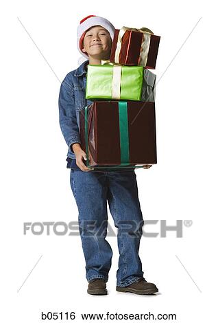 Boy with Christmas gifts View Large Photo Image Stock Photograph - Boy with Christmas gifts. Fotosearch