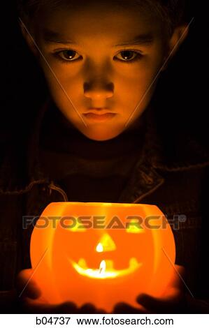 Stock Photo - Boy with jack o'lantern. Fotosearch