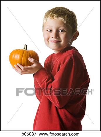 Stock Photo - Boy with pumpkin smiling. Fotosearch