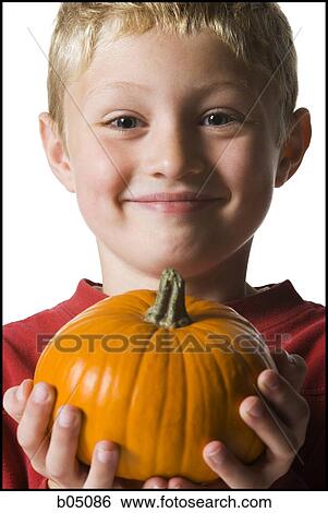 Stock Photograph - Boy with pumpkin smiling. Fotosearch