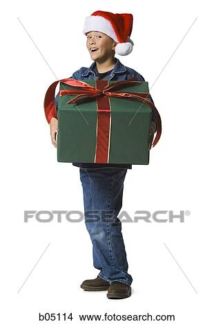 Boy with santa hat and Christmas gift View Large Photo Image Picture - Boy with santa hat and Christmas gift. Fotosearch