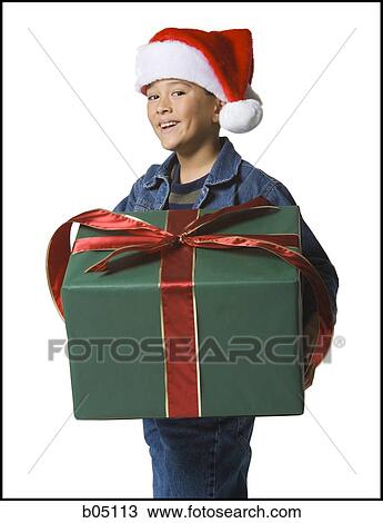 Boy with santa hat and Christmas gift View Large Photo Image Stock Image - Boy with santa hat and Christmas gift. Fotosearch