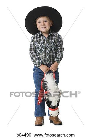 Boy with toy horse and cowboy hat View Large Photo Image Stock Image - Boy with toy horse and cowboy hat. Fotosearch