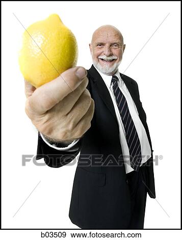 Business man holding lemon View Large Photo Image Stock Photo - Business man holding lemon. Fotosearch