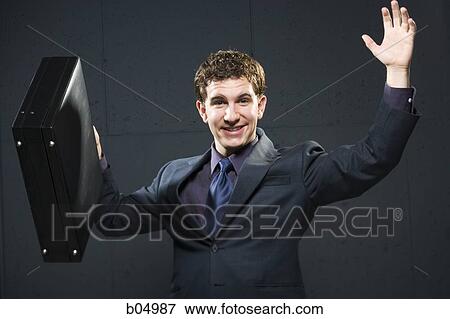 Business man with briefcase and arms up smiling View Large Photo Image Stock Photo - Business man with briefcase and arms up smiling. Fotosearch
