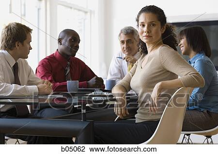 Stock Image - Business woman at meeting with five people. Fotosearch
