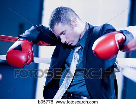 Businessman asleep in a boxing ring View Large Photo Image Stock Photo - Businessman asleep in a boxing ring. Fotosearch