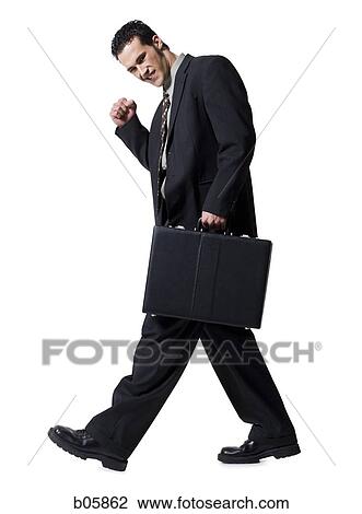Businessman carrying a briefcase View Large Photo Image Stock Image - Businessman carrying a briefcase. Fotosearch