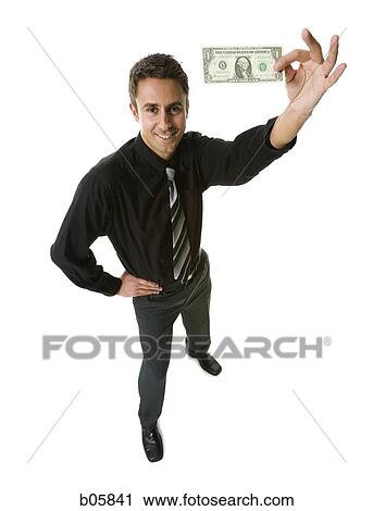 Businessman holding a one dollar bill View Large Photo Image Stock Image - Businessman holding a one dollar bill. Fotosearch
