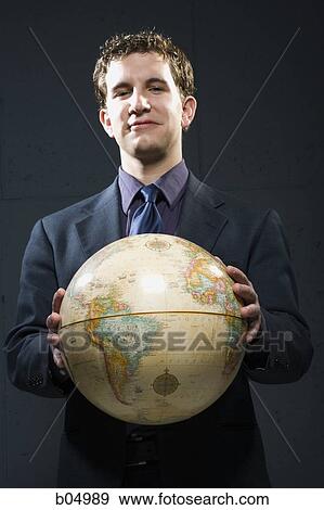 Businessman holding globe View Large Photo Image Stock Photo - Businessman holding globe. Fotosearch