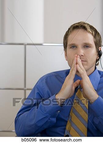 Businessman in cubicle with headset View Large Photo Image Stock Photograph - Businessman in cubicle with headset. Fotosearch