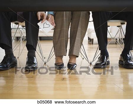Businessman passing love note to woman at meeting View Large Photo Image Stock Photo - Businessman passing love note to woman at meeting. Fotosearch