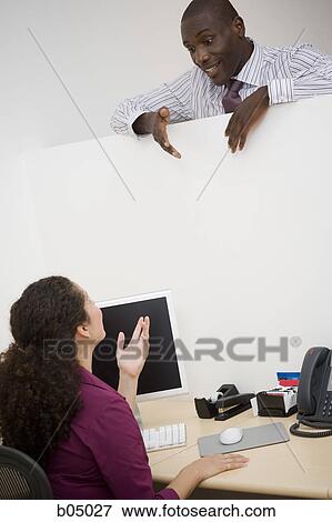 Businessman talking with woman over partition View Large Photo Image Stock Photo - Businessman talking with woman over partition. Fotosearch