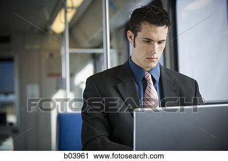 Businessman using laptop computer on city bus or subway View Large Photo Image Stock Image - Businessman using laptop computer on city bus or subway. Fotosearch