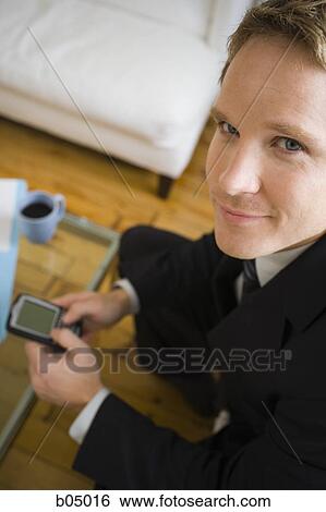 Businessman with blackberry smiling View Large Photo Image Stock Photograph - Businessman with blackberry smiling. Fotosearch