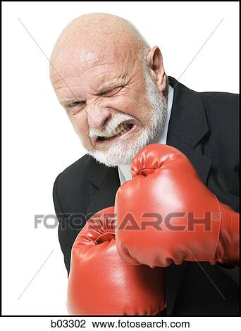 Stock Image - Businessman with boxing gloves. Fotosearch